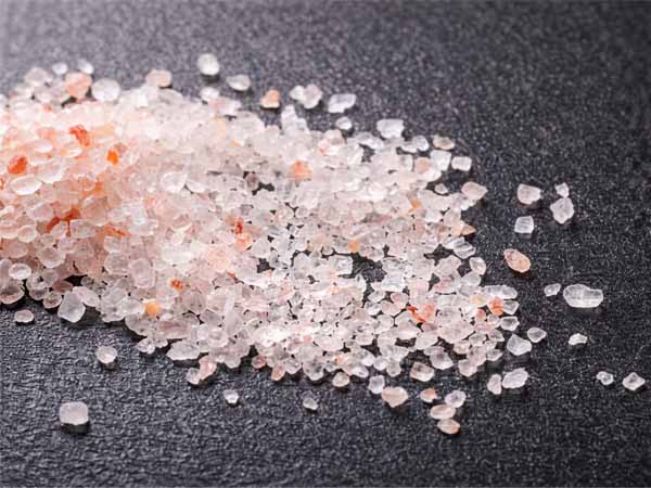 Measuring rock salt for coconut fertilizer application